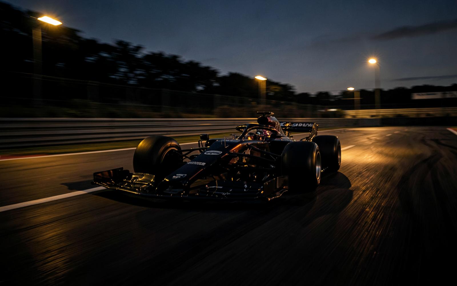 Formula 1 car on a floodlit street circuit at night
